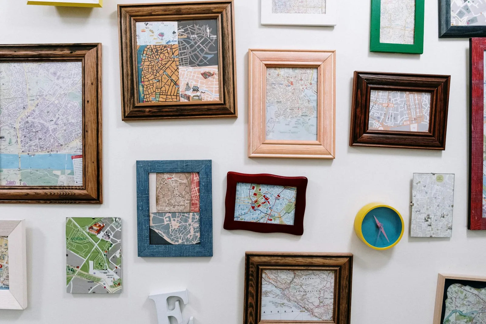 Wall of framed posters above a sofa